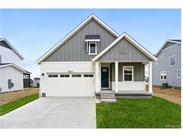Charming home featuring a two-car garage, stylish gray and white color scheme, and a well-manicured lawn at 39732 Penn Rd, Elizabeth, CO 80107