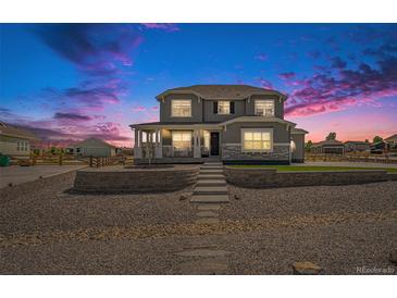 Charming two-story home with front porch and landscaped front yard, perfect curb appeal at 4532 Dewey Ln, Brighton, CO 80603