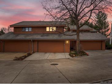 Stunning exterior of a brown two-story house with three-car garage under a colorful sky at 1276 Harrison Ct, Boulder, CO 80303