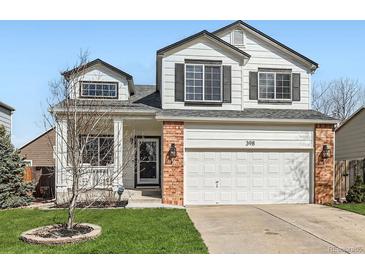 Charming two-story home with a well-manicured lawn, attached two-car garage, and attractive curb appeal at 398 Benton St, Castle Rock, CO 80104