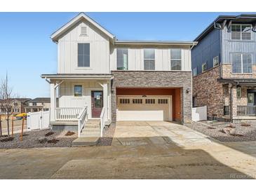 Charming two-story home with a stone facade and a two-car attached garage at 2056 S Haleyville Way, Aurora, CO 80018