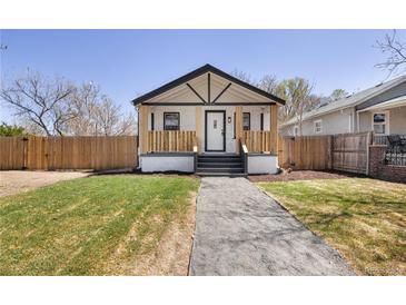 Charming home featuring a covered porch, a well-manicured lawn, and a pathway leading to the front door at 4780 Pennsylvania St, Denver, CO 80216