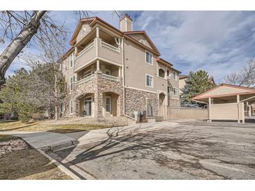 Inviting condo with stone accents, private balconies, and convenient covered parking at 8465 S Holland Way # 205, Littleton, CO 80128