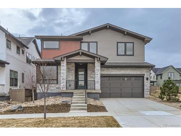 Charming two-story home with a modern gray exterior and stone accents and well-maintained landscaping at 5575 Moosehead Cir, Longmont, CO 80503