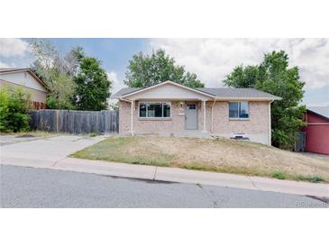 Charming single-story home featuring a well-maintained lawn and a classic brick facade at 230 W 78Th Pl, Denver, CO 80221