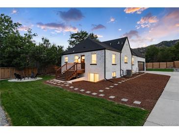 White brick home with landscaped yard, large driveway and a detached garage at 3360 Broadway St, Boulder, CO 80304