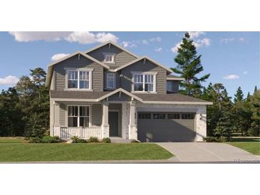 Charming two-story home with grey siding, a stone-accented garage, and a well-manicured lawn at 10760 Snowdon St, Parker, CO 80134