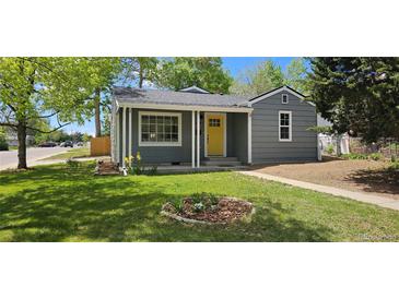Charming single-Gathering home with a well-manicured lawn and a bright yellow front door at 1089 S Osceola St, Denver, CO 80219