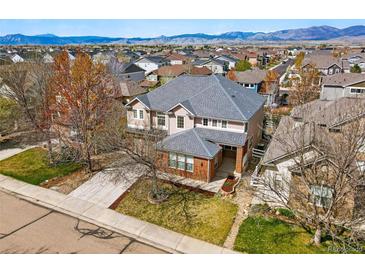 Stunning home with manicured lawn and view of the front exterior and neighboring homes at 5017 Bella Vista Dr, Longmont, CO 80503