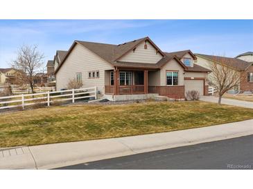 Charming two-story home with a covered porch, well-kept lawn, and white picket fence at 4143 Eagle Ridge Way, Castle Rock, CO 80104