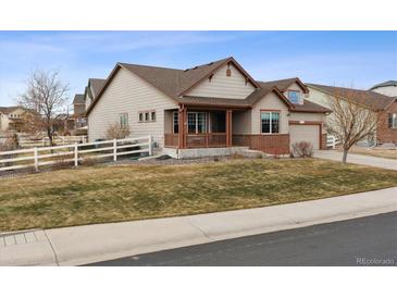 Charming home with a covered front porch and well-manicured lawn and inviting curb appeal at 4143 Eagle Ridge Way, Castle Rock, CO 80104