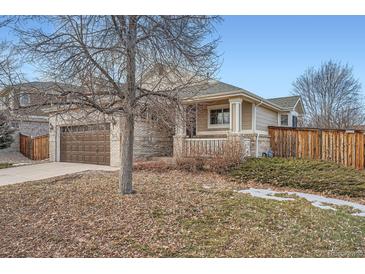 Brick ranch home with attached garage and landscaped yard at 20351 E Lasalle Pl, Aurora, CO 80013