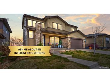 Charming two-story home featuring stone accents, a covered porch, and a well-maintained front yard at 14102 Night Owl Ln, Parker, CO 80134