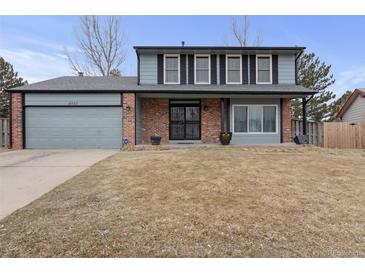 Charming two-story home boasts a well-maintained lawn, brick accents, and a welcoming entrance at 18982 E 46Th Ave, Denver, CO 80249