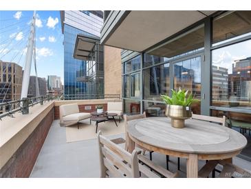 Relaxing balcony area with ample seating and a view of the surrounding city buildings and architectural features at 2100 16Th St # 600, Denver, CO 80202