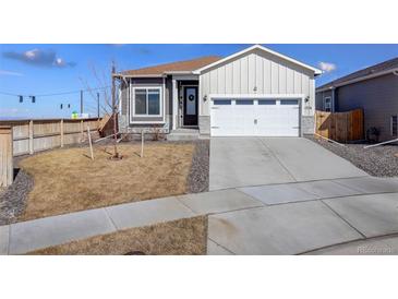 Charming exterior view of a two-story home, showing the garage, front yard, and well-maintained landscaping at 17761 E 95Th Pl, Commerce City, CO 80022