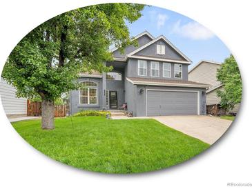 Charming two-story home with a well-maintained lawn, mature tree and a two car garage at 8838 S Dudley St, Littleton, CO 80128