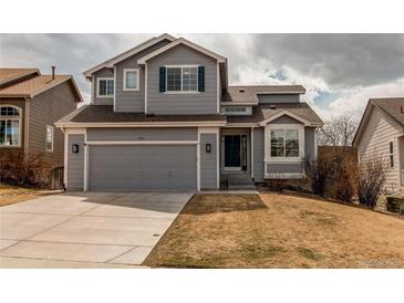 Charming two-story home with a gray exterior, attached garage, and well-maintained lawn at 468 English Sparrow Trl, Highlands Ranch, CO 80129