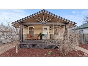 Charming bungalow with a covered porch, decorative wood elements, and inviting curb appeal at 3912 S Acoma St, Englewood, CO 80110