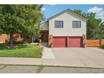 Beautiful two-story house with red door and attached two-car garage at 644 Munson Ct, Berthoud, CO 80513