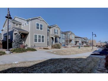 Attractive townhomes featuring neat landscaping and a sidewalk for pleasant neighborhood strolls at 15869 E Otero Ave, Centennial, CO 80112