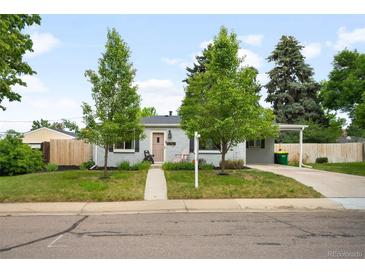 Charming single-story home with a well-maintained lawn, mature trees, and a quaint walkway leading to the front door at 5740 S Cherokee St, Littleton, CO 80120