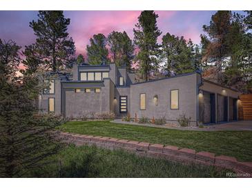 Stunning modern home with lush green lawn, mature trees, and inviting front entrance at 1559 Apex Rd, Franktown, CO 80116