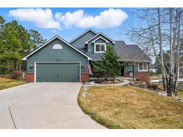 Charming two-story home showcasing a well-maintained yard and a two-car garage at 1330 Conifer Pl, Elizabeth, CO 80107