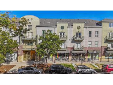 Charming exterior view of townhomes with balconies, sidewalk, street parking, and nearby shops at 837 E 17Th Ave # 2K, Denver, CO 80218