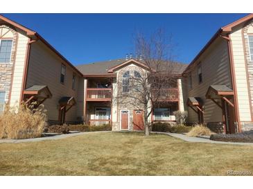 Charming condo building with two stories, private balconies, and well-maintained front lawn at 3282 E 103Rd Dr # 1604, Thornton, CO 80229