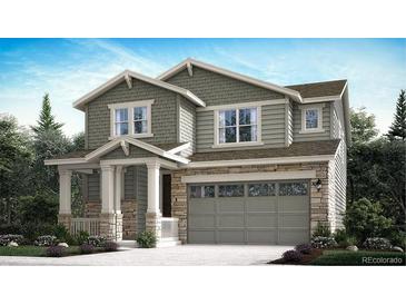Charming two-story home with stone accents, attached garage and covered porch at 28625 E 6Th Pl, Watkins, CO 80137