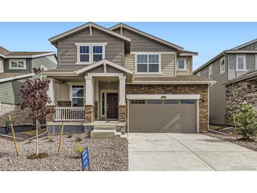 Charming two-story home featuring stone accents, neutral siding, and an attached two-car garage at 28625 E 6Th Pl, Watkins, CO 80137