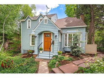 Charming home with light blue siding, arched entryway, and lovely landscaping at 1502 Columbine Ave, Boulder, CO 80302