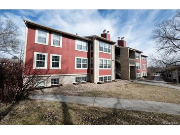 Red condominium building with trimmed windows, chimneys, and exterior staircase at 2686 E Otero Pl # 12, Centennial, CO 80122