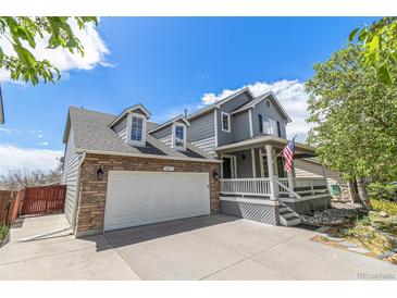Charming two-story home with a two car garage, covered porch, and landscaped yard at 821 S 34Th Ave, Brighton, CO 80601