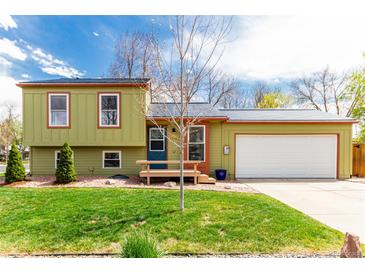 Charming exterior of a two-story home with a well-manicured lawn and attached garage on a sunny day at 2348 Sherman St, Longmont, CO 80501