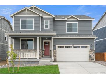 Beautiful two-story home featuring a charming front porch and a two-car garage at 14239 Beebalm Ave, Parker, CO 80134