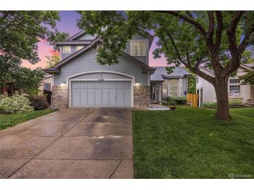 Charming two-story home boasts a well-manicured lawn and attached two car garage at 11263 Vrain Dr, Westminster, CO 80031