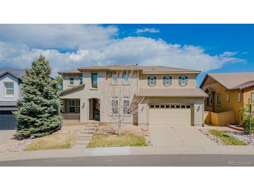 Stunning home with well-maintained lawn, neutral colors, mature landscaping and an attached two-car garage at 3873 Fairbrook Pt, Highlands Ranch, CO 80130