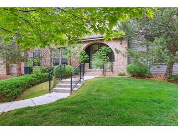 Charming brick home with an arched entryway, landscaped lawn, and inviting curb appeal at 22932 E Ontario Dr # 102, Aurora, CO 80016