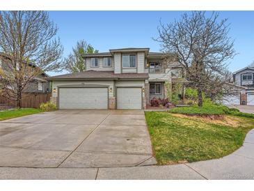 Charming two-story home features a well-maintained front yard and three-car garage at 8807 Tuscany Ln, Highlands Ranch, CO 80130