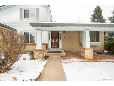 Inviting front exterior with a covered entryway and stone accents at 18360 E Ithaca Pl, Aurora, CO 80013