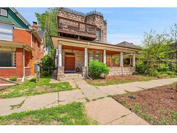 Unique stone house with a covered porch, balcony, and charming architectural details at 54 S Emerson St # 4, Denver, CO 80209