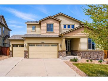 Inviting two-story home featuring a three-car garage, landscaped yard, and a charming covered entryway at 18083 Telford Ave, Parker, CO 80134