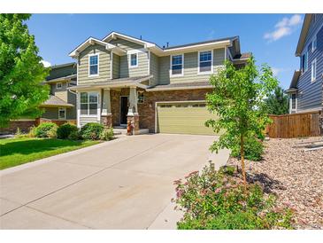 Charming two-story home with a well-manicured lawn, a long driveway, and a two-car garage at 5722 S Flat Rock Way, Aurora, CO 80016