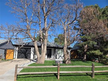 Charming home featuring mature trees, a well-manicured lawn, and a For Sale sign at 1130 S Harrison St, Denver, CO 80210