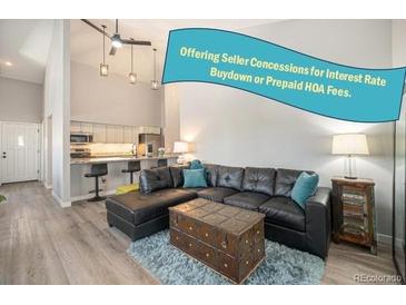 Inviting living room features a comfortable leather sectional sofa and stylish decor, perfect for relaxation at 2279 E 129Th Ave, Thornton, CO 80241