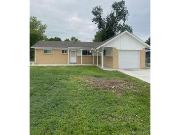 Charming single story home with attached garage and generous front yard at 8220 E 104Th Way, Henderson, CO 80640