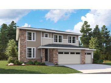 Two-story home with stone and siding, attached two-car garage, and well-manicured lawn at 5628 Riverbend Ave, Firestone, CO 80504