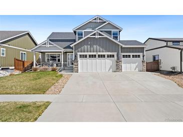 Two-story home featuring a three car garage and covered porch at 208 Dorothy Dr, Berthoud, CO 80513